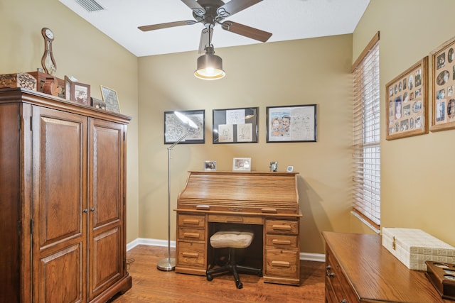 home office featuring wood-type flooring and ceiling fan