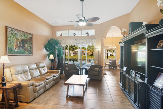 living room featuring ceiling fan with notable chandelier and tile patterned floors