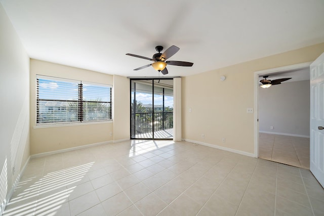 tiled empty room featuring ceiling fan