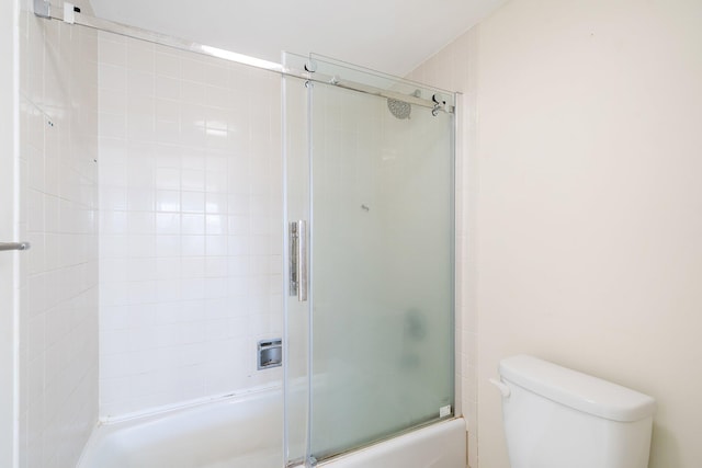 bathroom featuring shower / bath combination with glass door and toilet