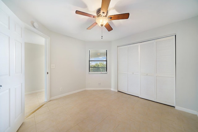 unfurnished bedroom featuring light tile patterned flooring, ceiling fan, and a closet