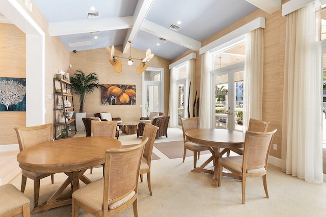 carpeted dining space featuring lofted ceiling with beams and french doors