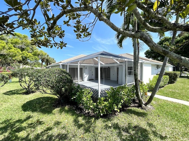 exterior space with a yard, a lanai, and a patio area