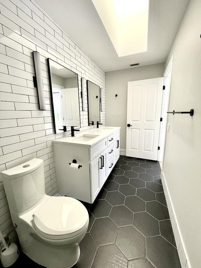 bathroom with vanity, tile patterned floors, and toilet