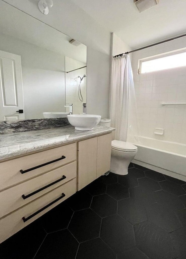 full bathroom with shower / bath combo with shower curtain, tile patterned floors, toilet, and vanity