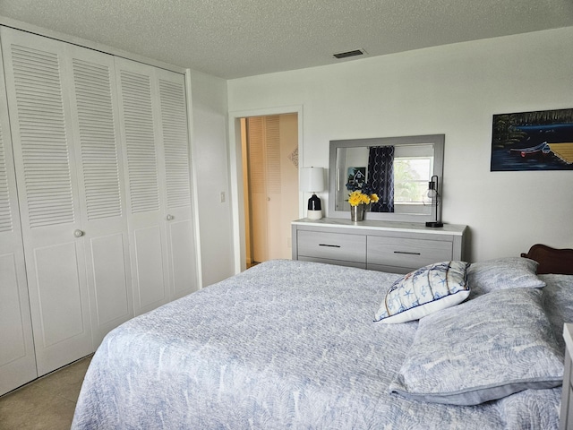 tiled bedroom featuring a textured ceiling and a closet