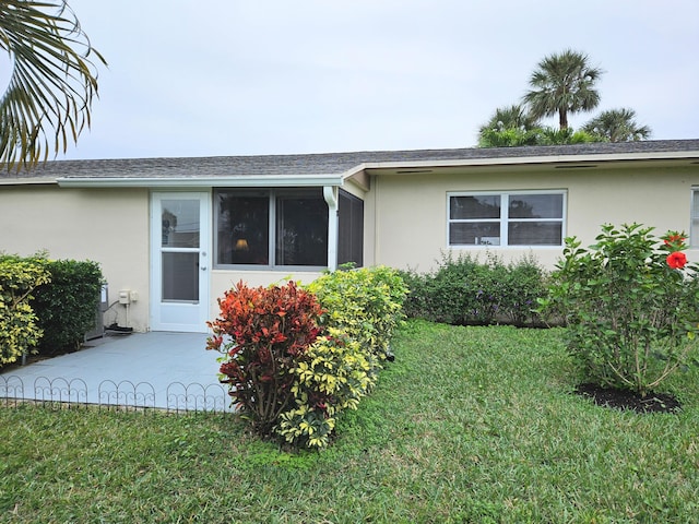 single story home with a patio and a front lawn