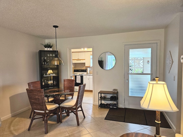 dining room featuring light tile patterned floors and a textured ceiling