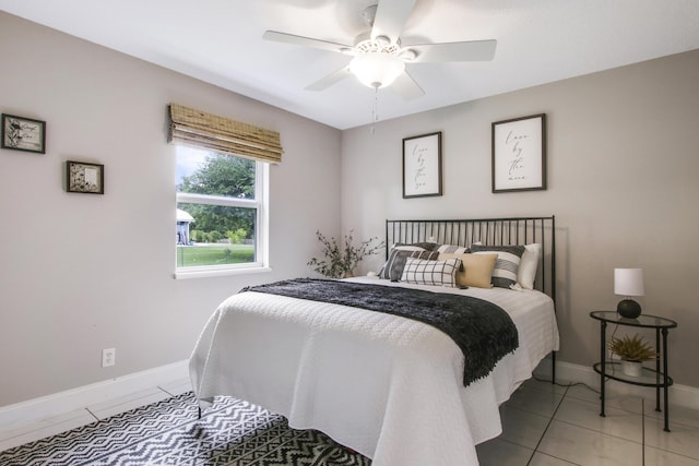 tiled bedroom featuring ceiling fan