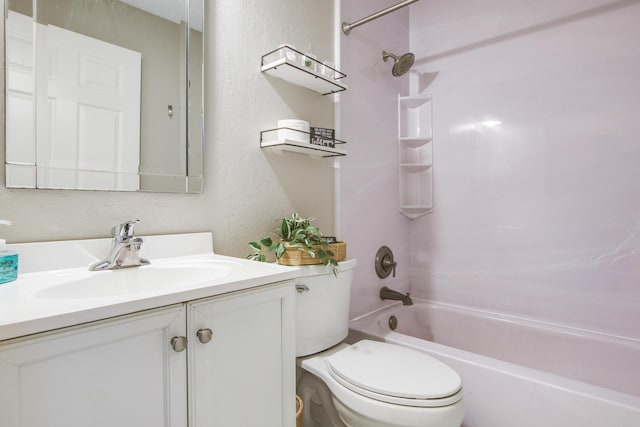 full bathroom featuring washtub / shower combination, vanity, and toilet