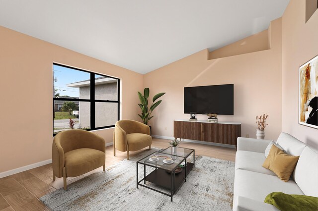 living room featuring lofted ceiling and light wood-type flooring