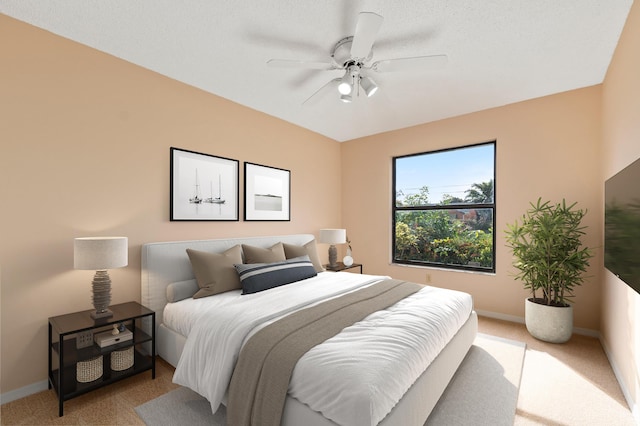 bedroom with ceiling fan and light carpet