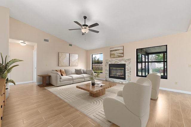 living room featuring ceiling fan, high vaulted ceiling, a healthy amount of sunlight, and light hardwood / wood-style floors