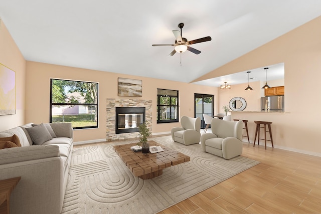 living room with lofted ceiling, light hardwood / wood-style floors, and ceiling fan