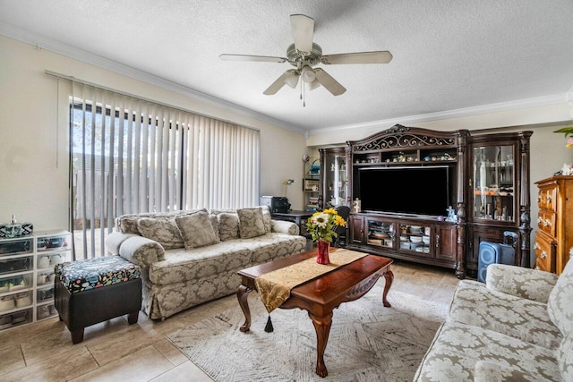 tiled living room featuring ceiling fan, ornamental molding, and a textured ceiling