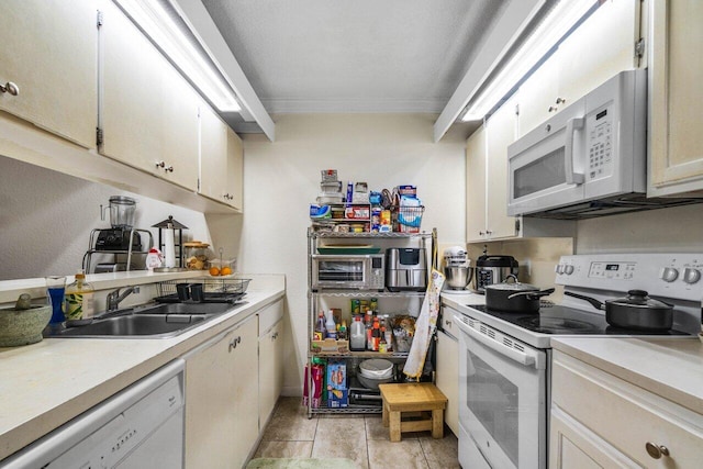 kitchen featuring sink, white appliances, and ornamental molding
