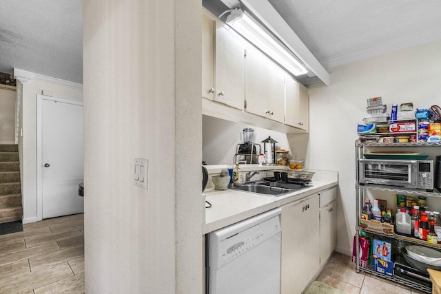 kitchen with sink, crown molding, white dishwasher, a textured ceiling, and white cabinets