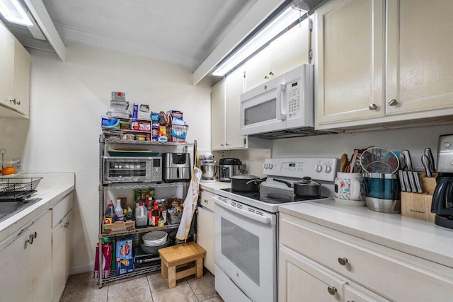 kitchen with crown molding, white appliances, white cabinets, and light tile patterned floors