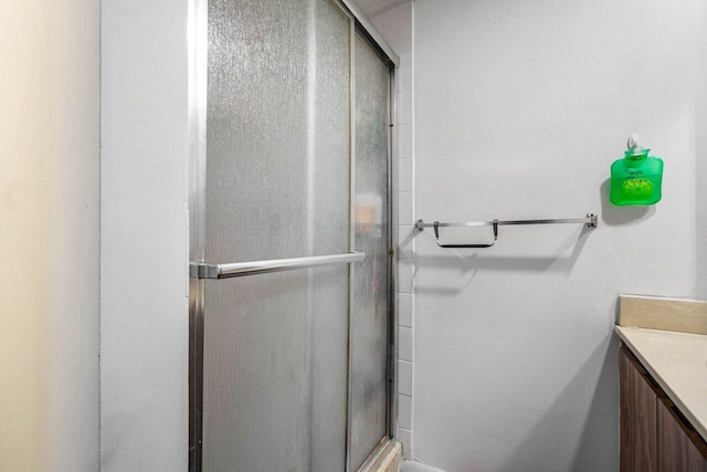 bathroom featuring vanity and an enclosed shower
