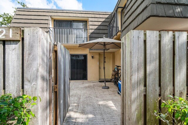 view of exterior entry featuring a patio area