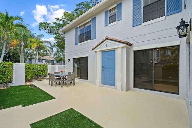 rear view of property with a lawn and a patio area