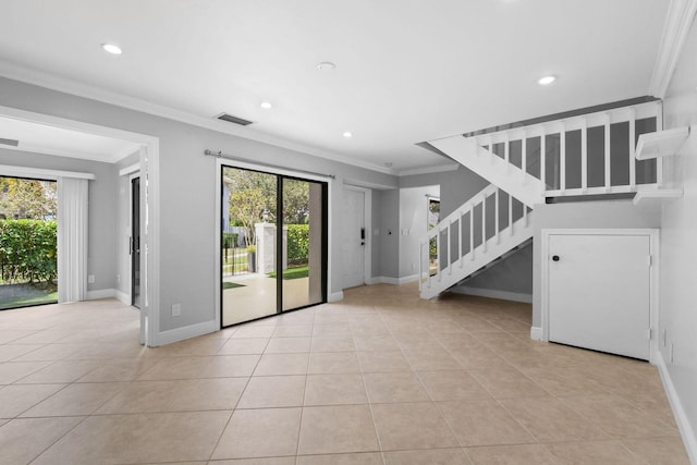 unfurnished living room with ornamental molding, a wealth of natural light, and light tile patterned floors