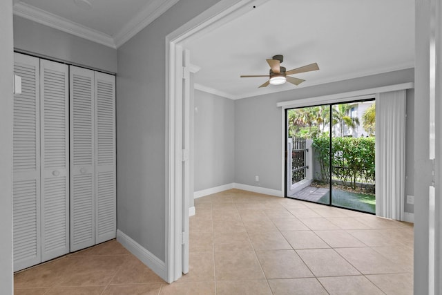 unfurnished bedroom with crown molding, access to outside, light tile patterned floors, a closet, and ceiling fan