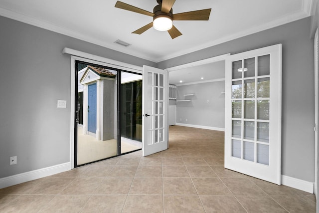 tiled spare room with crown molding, ceiling fan, and french doors