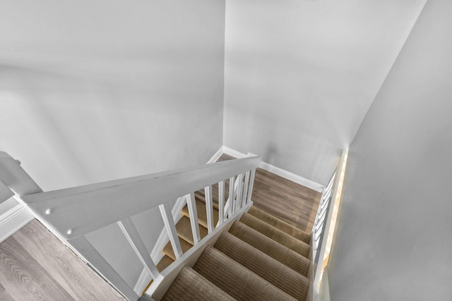 staircase with wood-type flooring