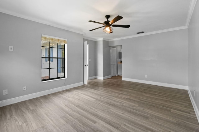 unfurnished room featuring wood-type flooring, ornamental molding, and ceiling fan