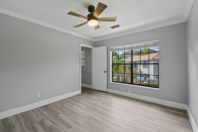 spare room with crown molding, light hardwood / wood-style floors, and ceiling fan