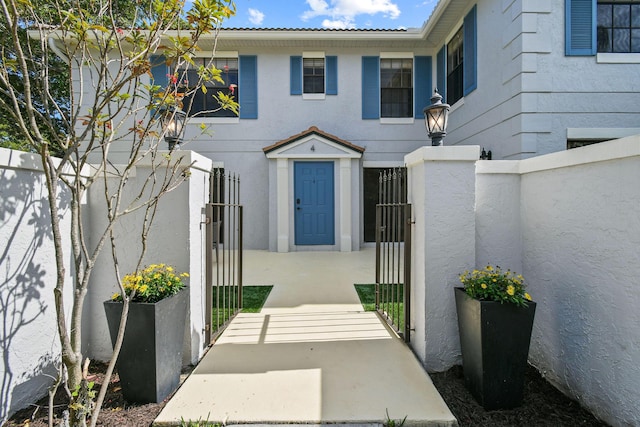 view of exterior entry with a patio area