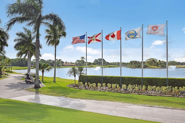 view of property's community featuring a yard and a water view