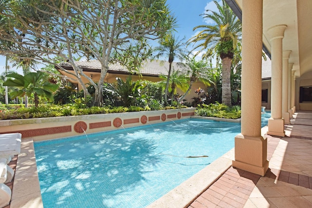 view of swimming pool with pool water feature