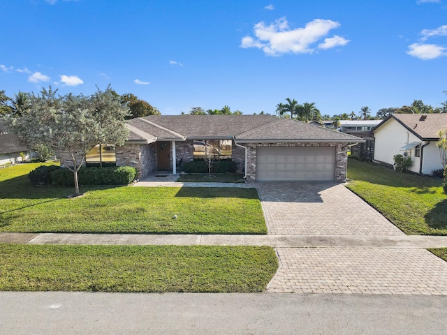 ranch-style house with a garage and a front lawn