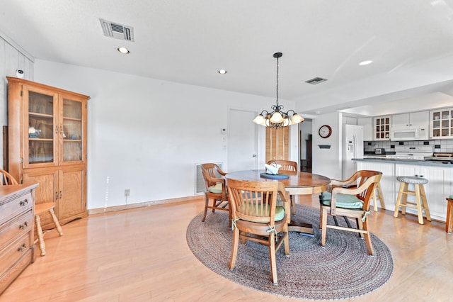 dining room featuring an inviting chandelier and light hardwood / wood-style floors