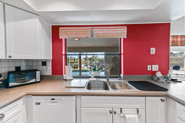 kitchen with a healthy amount of sunlight, sink, white cabinets, and white dishwasher