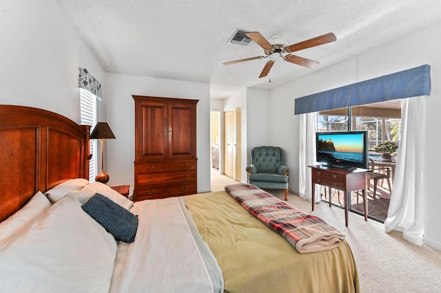 carpeted bedroom with ceiling fan, a textured ceiling, and access to outside