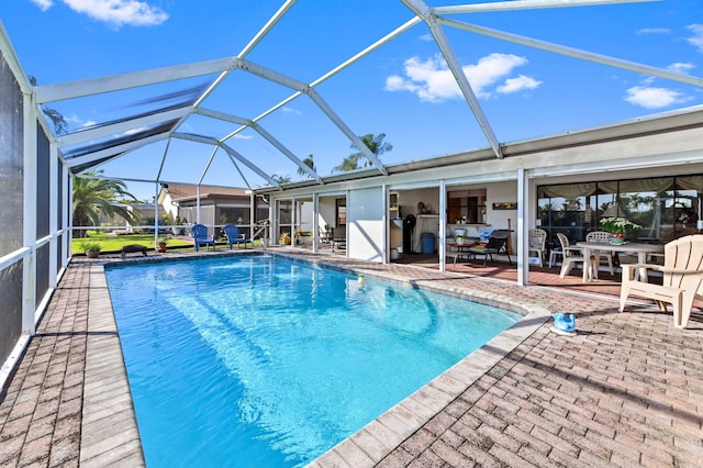 view of pool featuring a patio and glass enclosure