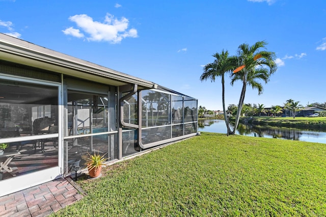 view of yard featuring a water view and a lanai