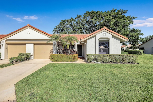 view of front of property featuring a garage and a front lawn