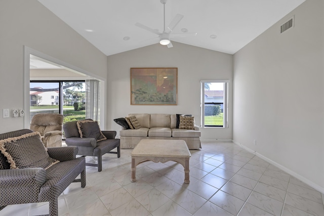 living room with lofted ceiling, a wealth of natural light, and ceiling fan