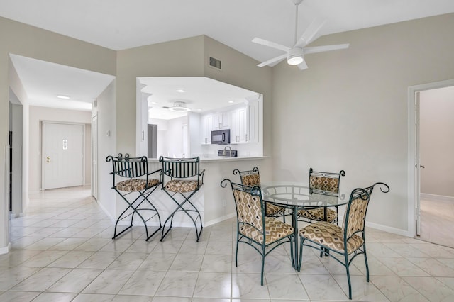 tiled dining space featuring ceiling fan