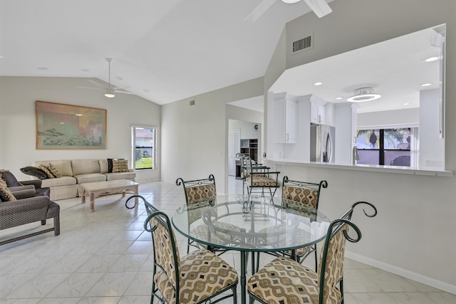 dining space with sink, vaulted ceiling, and ceiling fan