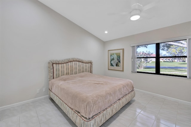 bedroom with lofted ceiling, light tile patterned floors, and ceiling fan