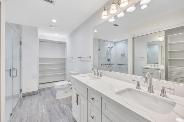 bathroom with vanity, toilet, and walk in shower