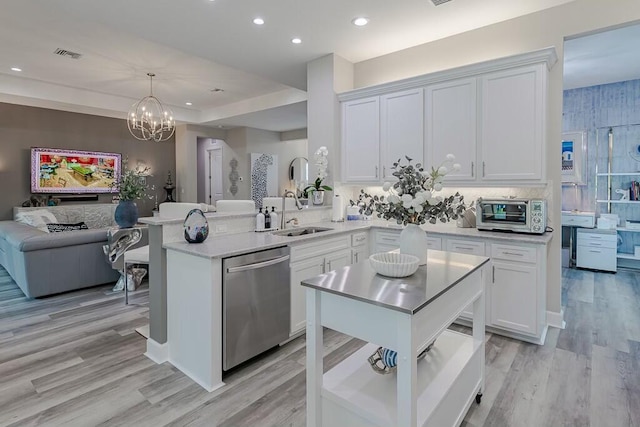 kitchen featuring white cabinetry, a toaster, a sink, light countertops, and stainless steel dishwasher