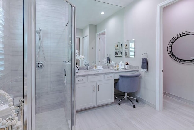 full bathroom with vanity, a shower stall, recessed lighting, and baseboards