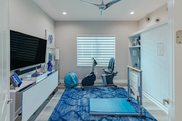 exercise area with light wood-style flooring, recessed lighting, and baseboards