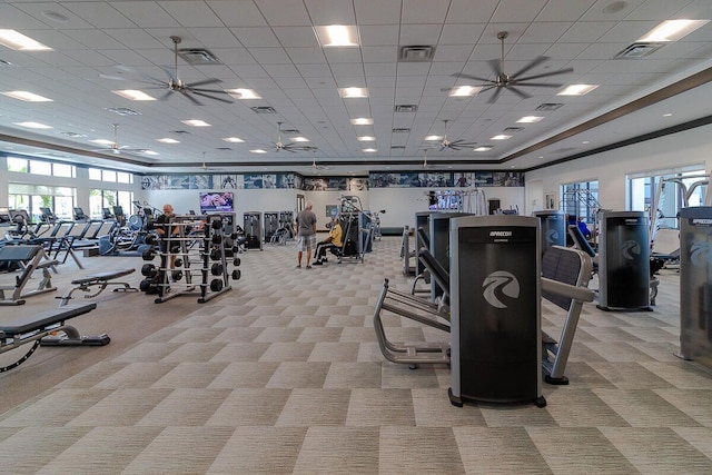 gym featuring light carpet, visible vents, and a ceiling fan